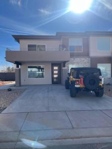 a jeep parked in front of a house at Water Canyon 4bd3Bath HotTubDeck in Hildale