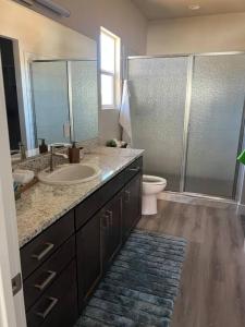 a bathroom with a sink and a toilet and a shower at Water Canyon 4bd3Bath HotTubDeck in Hildale