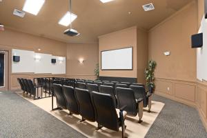 a conference room with black chairs and a screen at Windsor Hills Resort- 204A in Orlando