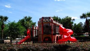 a playground with a red slide in a park at Windsor Hills Resort- 205 in Orlando