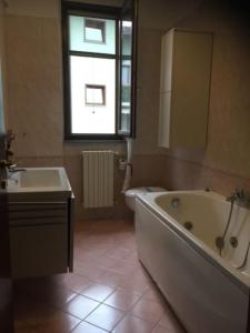 a bathroom with a tub and a sink and a bath tub at B&B Universo in Codogno