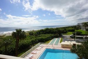 a view of a swimming pool and the beach at Canaveral Towers Oceanfront 402! in Cape Canaveral