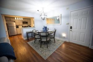 a kitchen and dining room with a table and chairs at Smooth 2/2 Condo in Buckhead, ATL in Atlanta