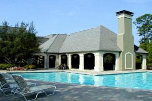 a swimming pool with chairs and a house at Smooth 2/2 Condo in Buckhead, ATL in Atlanta
