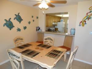 a kitchen and dining room with a table and chairs at Spanish Main Unit 4- Direct Oceanfront Condo! in Cocoa Beach