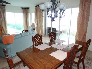 a living room with a table and a blue couch at 3800 Ocean Blvd Luxury 501- Direct Oceanfront Condo! in Cocoa Beach