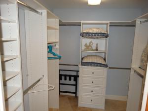 a closet with white cabinets and a white dresser at 3800 Ocean Blvd Luxury 501- Direct Oceanfront Condo! in Cocoa Beach