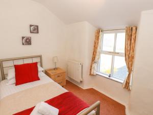 1 dormitorio con cama y ventana en Jasmine Cottage, en Windermere