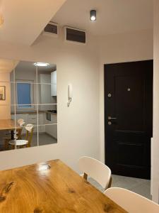 a dining room with a wooden table and white chairs at Apartament Mony in Timişoara