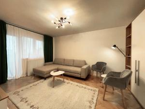 a living room with a couch and a table and chairs at Apartament Mony in Timişoara