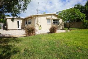 a small yellow house with a yard at NEW! 219 Garfield Ave in Cocoa Beach