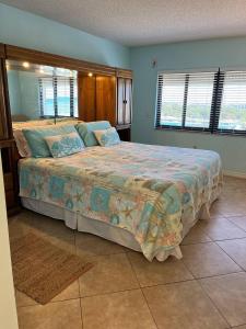 a bedroom with a large bed in a room at Sandcastles 704- Space Coast Oceanview! in Cocoa Beach