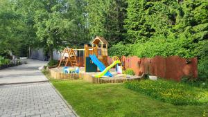 a backyard with a playground with a slide at Ferienwohnungen Kricklsäge in Philippsreut