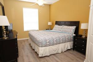 a bedroom with a bed and a window at Windsor Hills Resort- 401 in Orlando