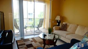 a living room with a couch and a glass table at Windsor Hills Resort- 401 in Orlando
