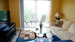 a living room with a couch and a table at Windsor Hills Resort- 401 in Orlando
