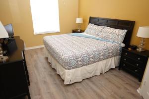 a bedroom with a bed with a wooden floor at Windsor Hills Resort- 401 in Orlando