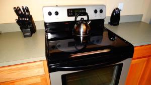 a tea kettle sitting on top of a stove in a kitchen at Windsor Hills Resort- 401 in Orlando