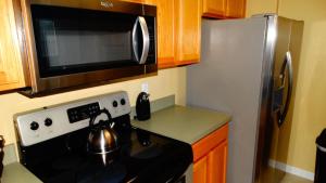 a kitchen with a black stove and a microwave at Windsor Hills Resort- 401 in Orlando