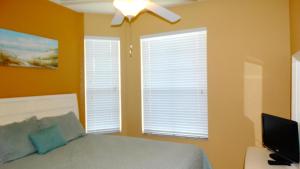 a bedroom with a bed and a ceiling fan at Windsor Hills Resort- 401 in Orlando