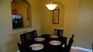 a dining room with a black table and chairs at Windsor Hills Resort- 401 in Orlando