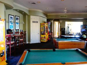 a billiard room with a pool table and a restaurant at Windsor Hills Resort- 401 in Orlando