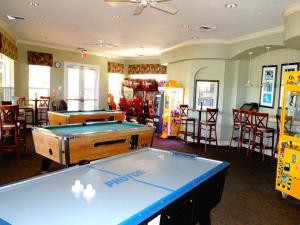 a room with a pool table and some tables and chairs at Windsor Hills Resort- 401 in Orlando