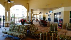 a lobby with chairs and a table with flowers on it at Windsor Hills Resort- 401 in Orlando