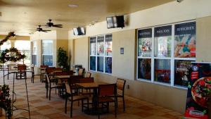 a dining room with tables and chairs in a restaurant at Windsor Hills Resort- 401 in Orlando