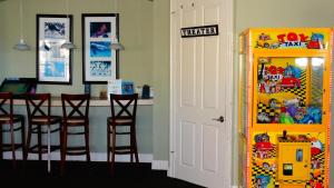 a room with a bar with stools and a table at Windsor Hills Resort- 401 in Orlando