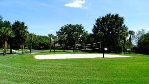 a park with a volleyball net in the grass at Windsor Hills Resort- 401 in Orlando