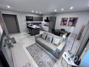 a living room with a couch and a kitchen at Le Porte luxury apartment in Aosta
