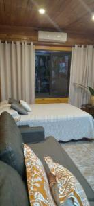 Una cama o camas en una habitación de Viví Iguazú Casa Familiar