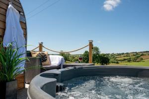 a hot tub on the patio of a house at Derwen in Welshpool