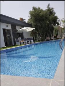 ein großer blauer Pool vor einem Haus in der Unterkunft Villa Toufitri in Agadir