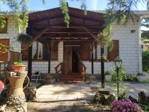 a wooden entrance to a house with a porch at La Casa di Anna nel Parco della Majella Abruzzo Rapino CH in Rapino