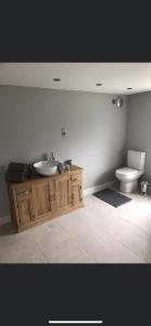 a bathroom with a sink and a toilet at Inviting 2-Bed Bungalow in Heacham with spa bath in Heacham