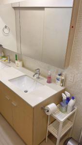 a bathroom counter with a sink and a mirror at 5 mins walk to Skytrain Station in Vancouver