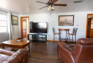 a living room with a couch and a flat screen tv at Two Bedroom Home - Walking Distance from The Beach in Jacksonville Beach