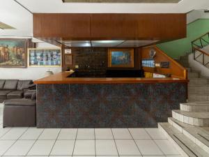a kitchen with a bar and a couch in a room at Hotel Canada in Guadalajara