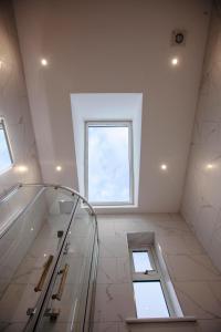 a bathroom with a glass shower and a window at Luxury House in Clitheroe in Clitheroe