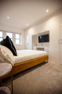 a large bedroom with a large bed and a tv at Luxury House in Clitheroe in Clitheroe