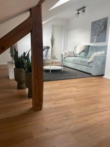 a living room with a couch and a table at FederKern Simonskall in Hürtgenwald