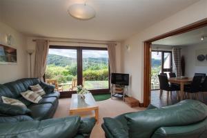 a living room with a couch and a table and a television at Rothay 18 in Ambleside