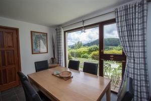 a dining room with a table and a large window at Rothay 18 in Ambleside