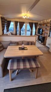 a living room with a table and a couch at 180 Golden Gate North Wales in Abergele