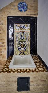 a bath tub in a room with a tile floor at Casa Pureza in Seville