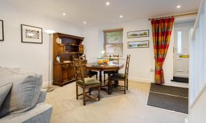 a kitchen and dining room with a table and chairs at Fern Cottage in Ambleside