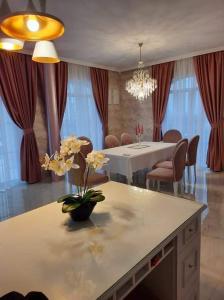 a living room with a table and a dining room with a dining room at Diamond Villas in Enina