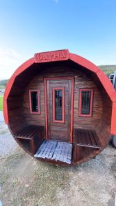a small wooden cabin with a sign on it at Diamond Villas in Enina
